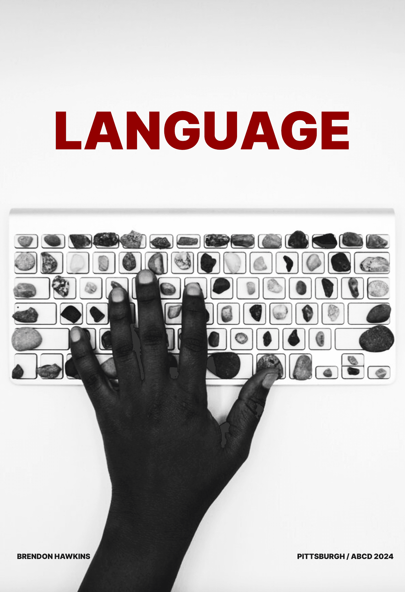 The word Language in dark red above a black-and-white photograph of a hand on a keyboard whose keys contain individual stones.