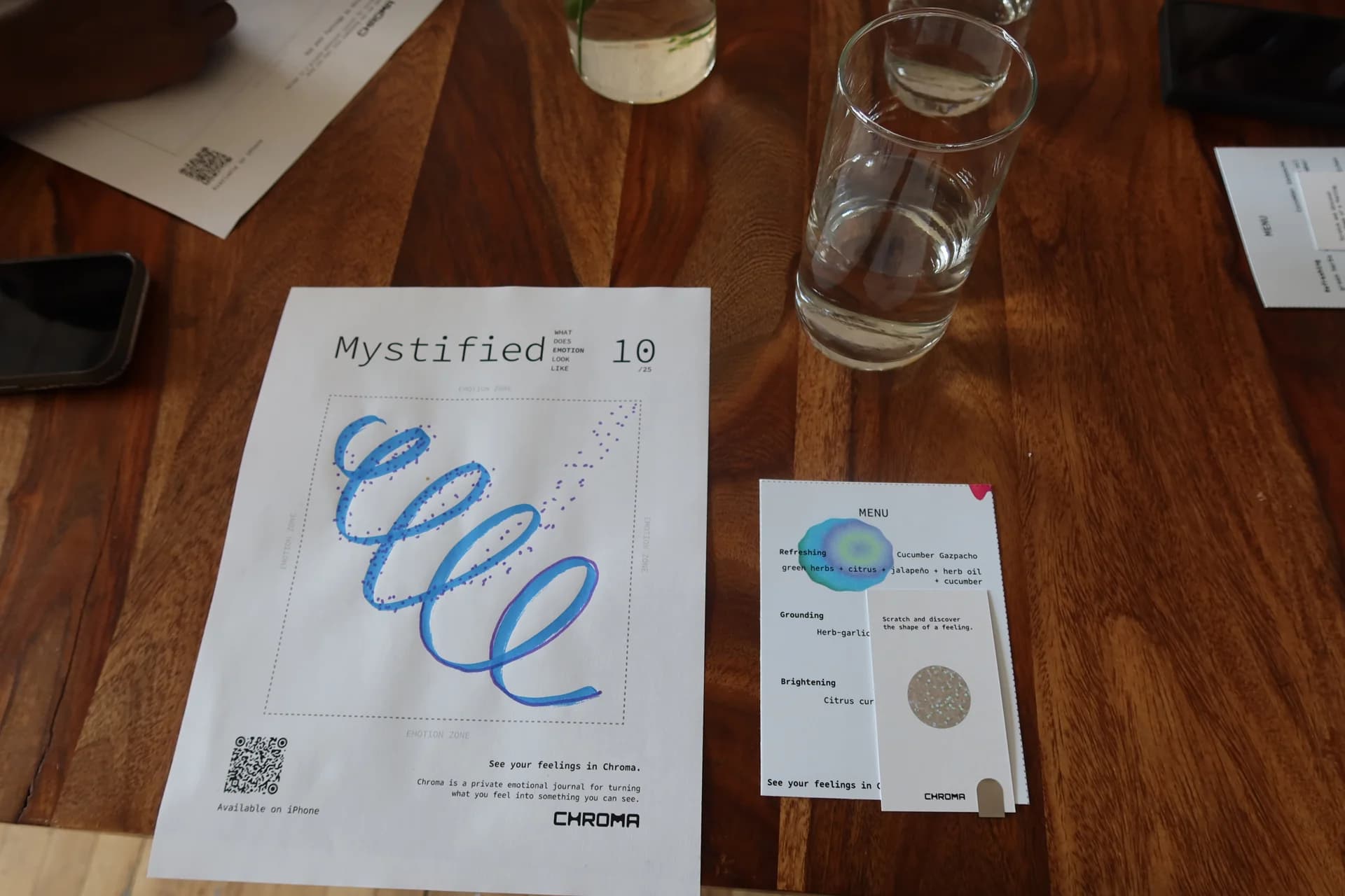 A blue and violet spiral on the Mystified worksheet, alongside the printed menu and Chroma card.