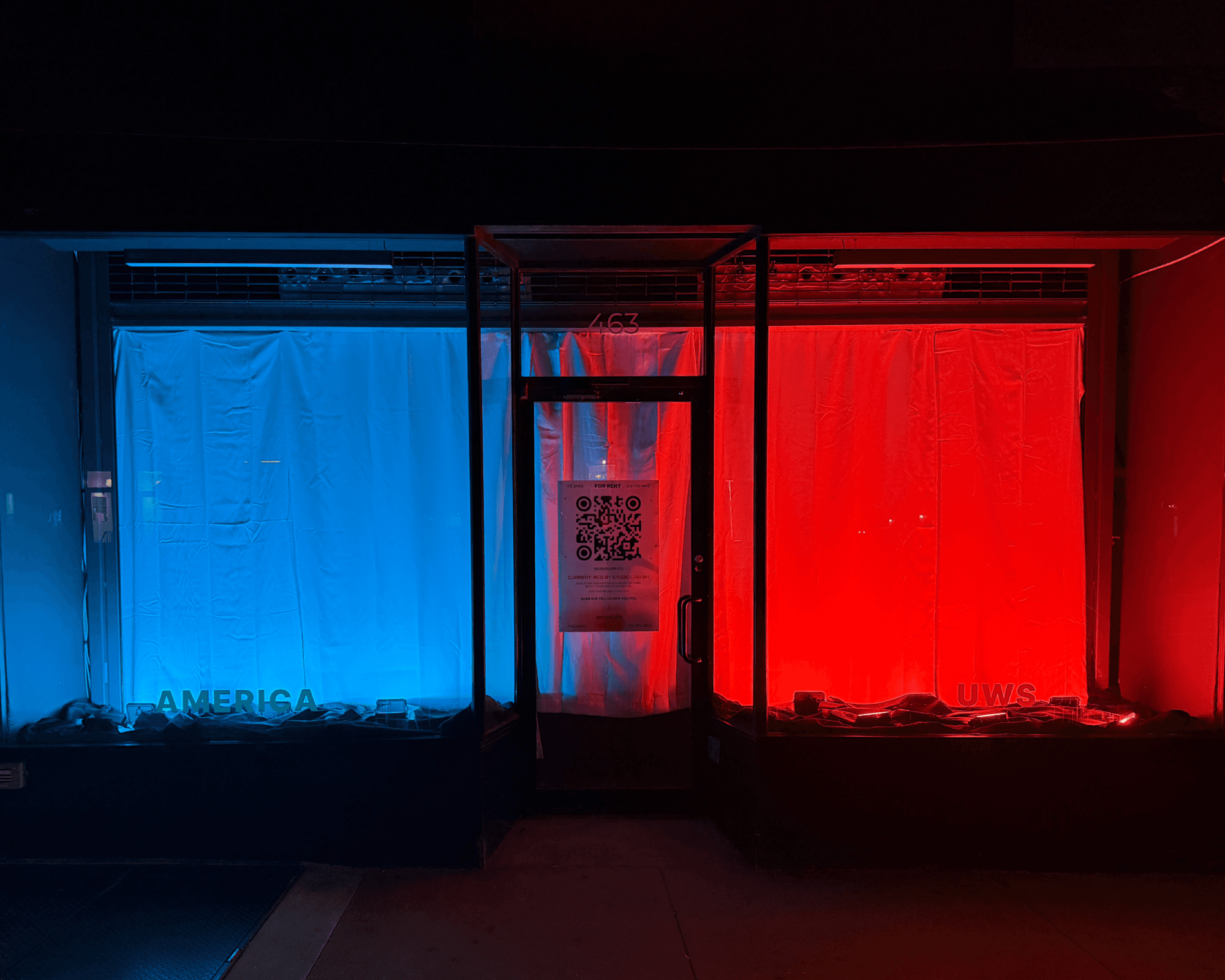 ACG storefront at night with a blue America field and a red UWS field
