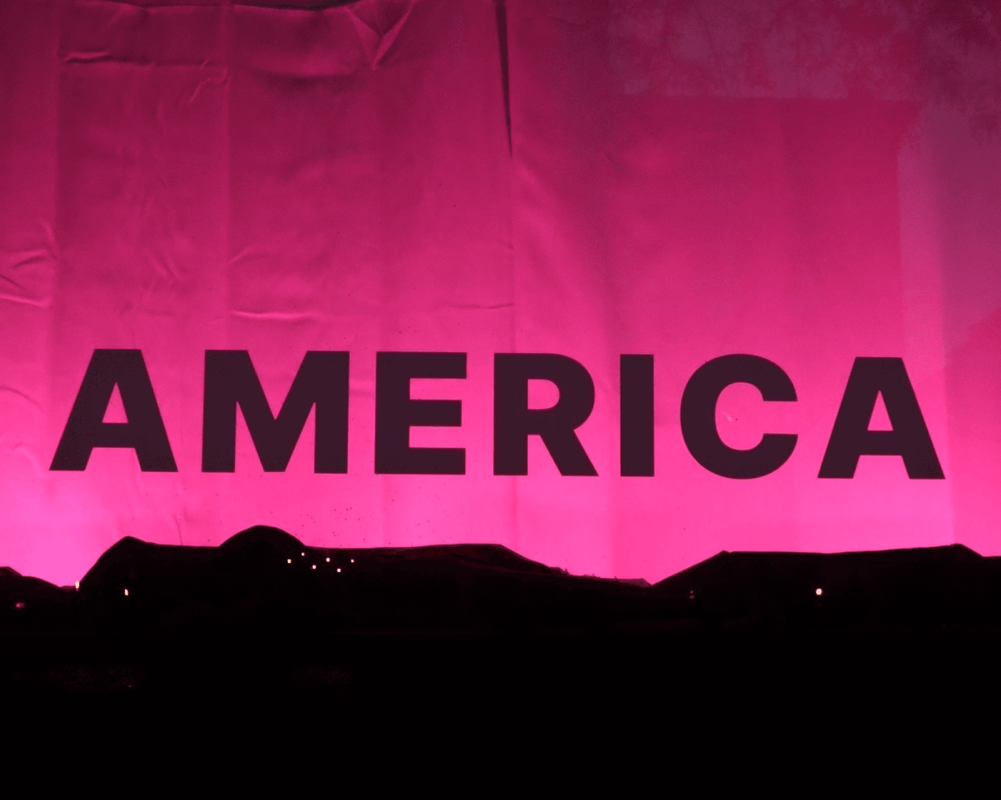 The America light array illuminating a curtain in violet and pink